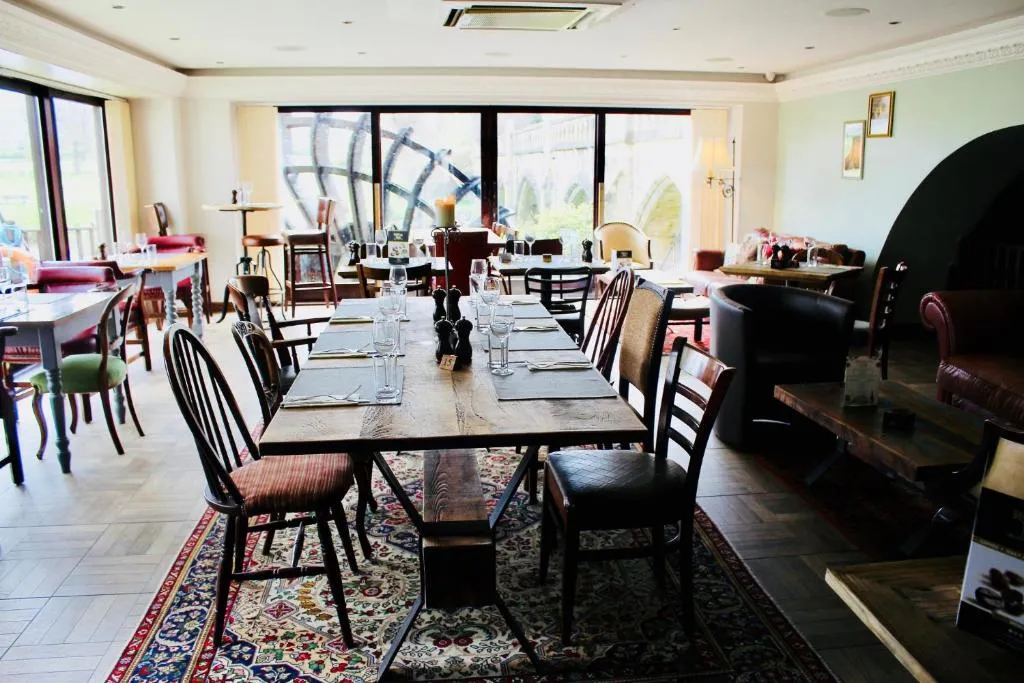 Restaurant dining room with the waterwheel visible through the arched windows