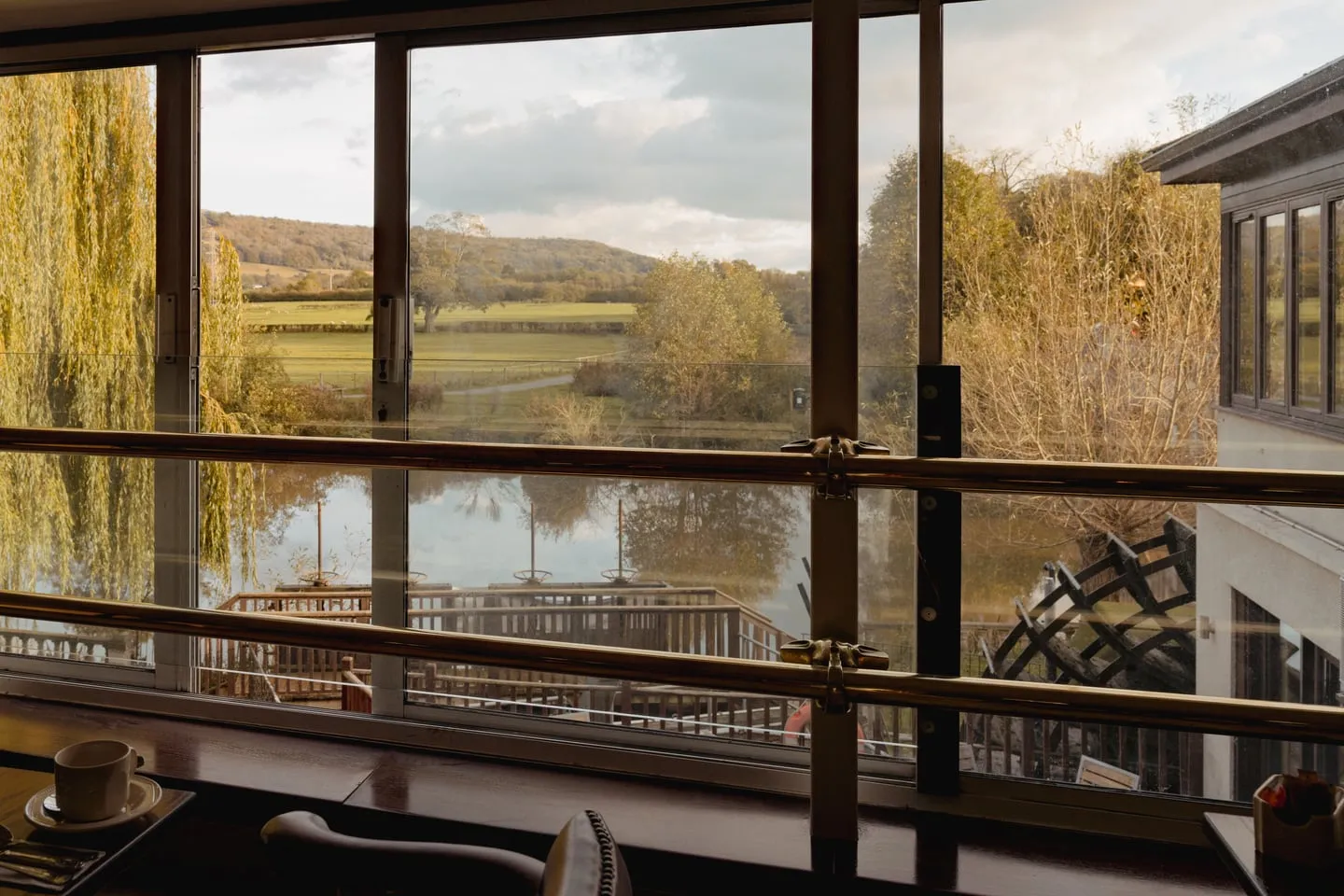 A window table in the restaurant looking across the Avon, with the waterwheel beyond the glass