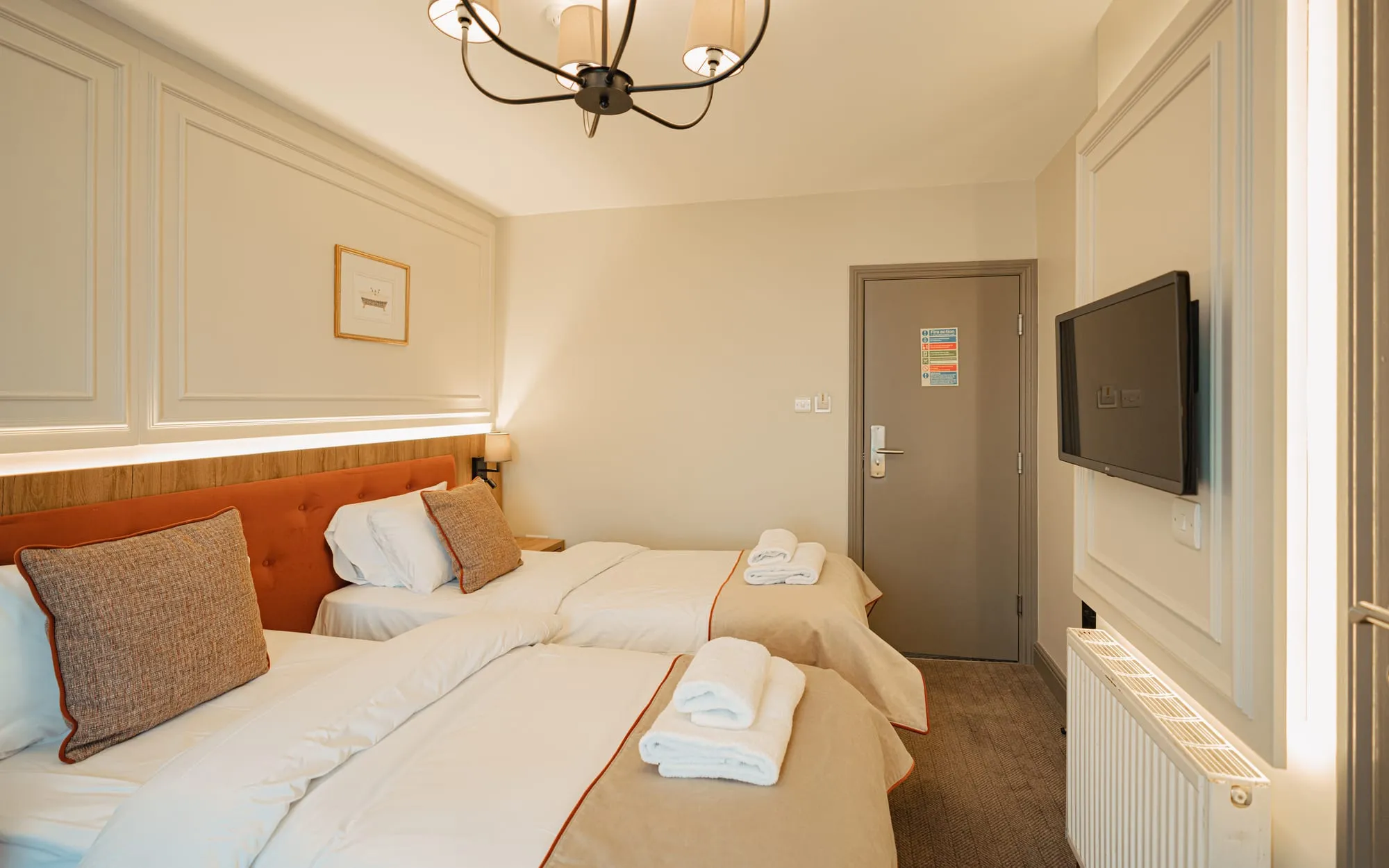 Standard Twin with two single beds, panelled walls and a chandelier